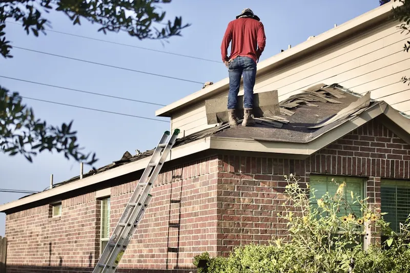 Professional roofer working on a residential roof in Sugar Hollow Farm